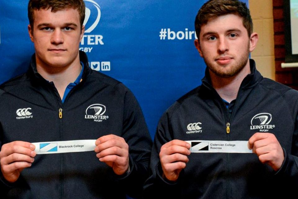 Josh Van Der Flier, left, Leinster Academy player, draws out the name of Blackrock College, and Ian Fitzpatrick, Leinster Academy player, draws out the name of Cistercian College Roscrea