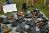 thumbnail: A stall tender shows his 'upcycled' Wellington boots for sale at the Glastonbury Festival of Music and Performing Arts on Worthy Farm near the village of Pilton in Somerset, South West England, on June 26, 2019. (Photo by Oli SCARFF / AFP)OLI SCARFF/AFP/Getty Images