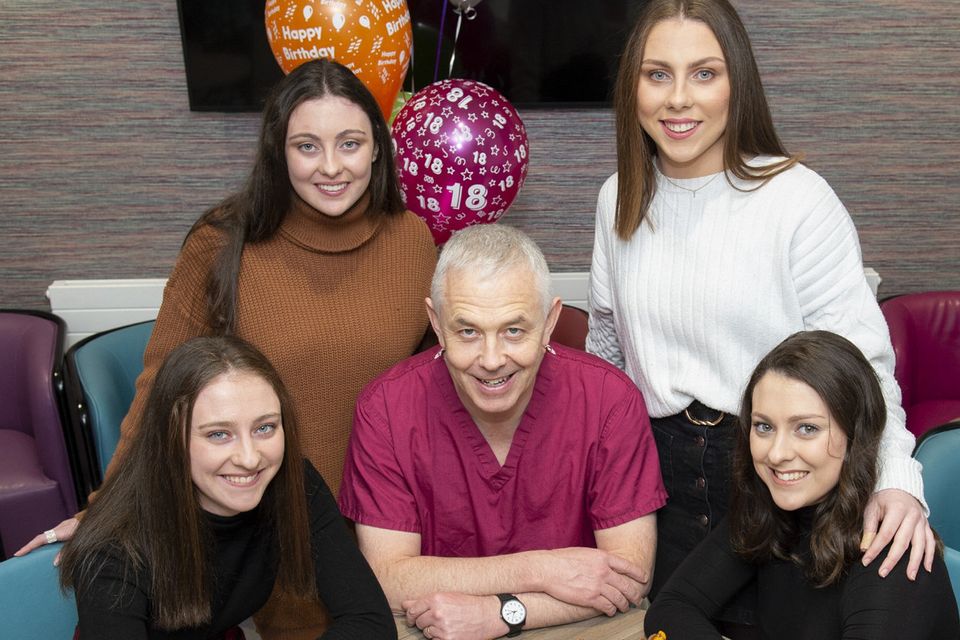 Cake for four: Consultant Professor John R Higgins with Katie, Kellie, Amy and Shauna Murphy