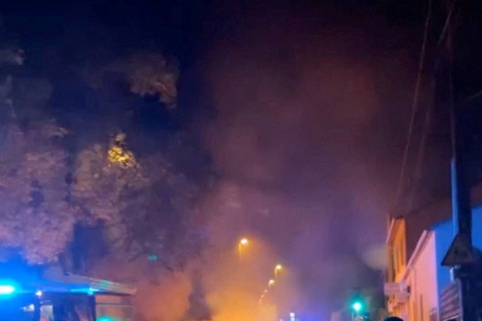 A firefighter works to extinguish the fire as clashes break out while a police officer is being investigated after a 17-year-old was shot dead, in Nanterre, France June 27, 2023, in this still image obtained from a social media video. Eva Gueye/via REUTERS