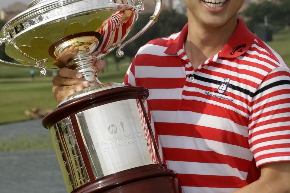 Sang-Moon Bae of South Korea holds the trophy on the 18th green after winning the Byron Nelson in Texas