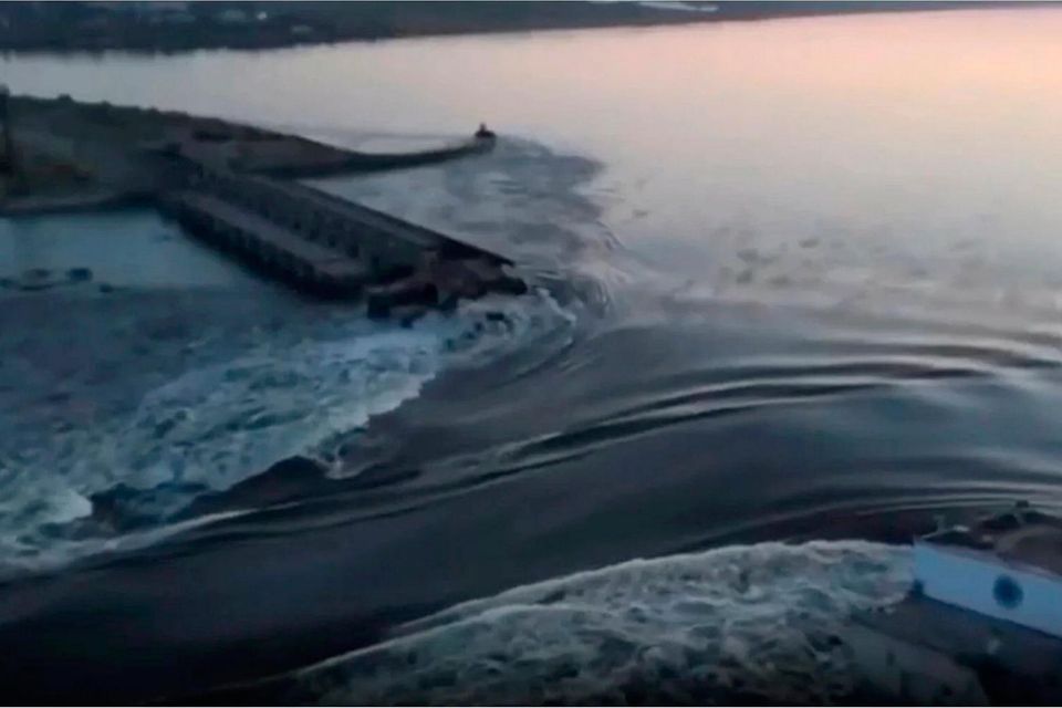 In an image taken from video released by the Ukrainian Presidential Office, water runs through a breakthrough in the Kakhovka dam in Kakhovka, Ukraine. Photo: AP