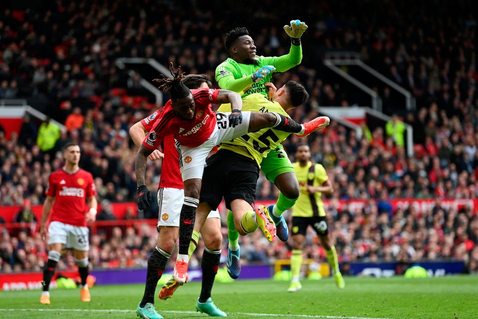 Manchester United goalkeeper André Onana fouls Zeki Amdouni of Burnley to concede a penalty