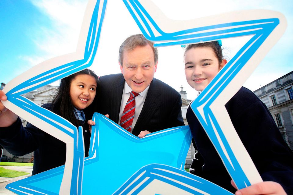 Taoiseach Enda Kenny with Sosfia Corpuz, left, and Emily Lee-Duff from St Vincent’s Girls National School, Dublin, yesterday at the launch of the Blue Star Programme for this school year. Photo: Tom Burke