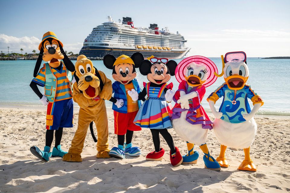 Goofy, Pluto, Mickey, Minnie, Daisy and Donald on Castaway Cay, in front of the docked Disney Treasure. Photo: PA
