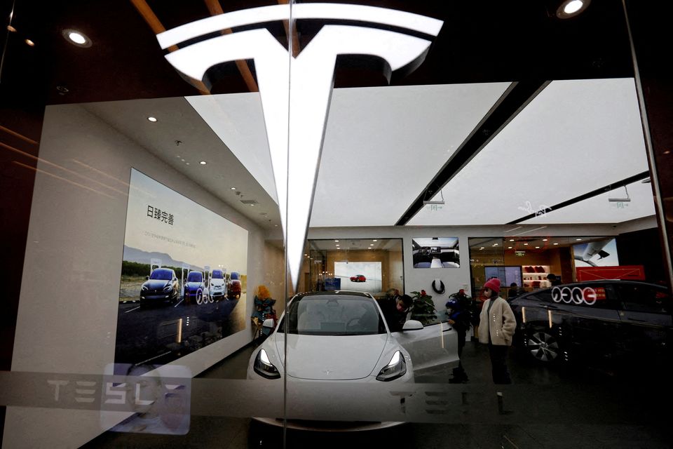 Visitors check a Tesla Model 3 car in Beijing, China February 4, 2023. Photo: Florence Lo/Reuters