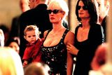 thumbnail: (AUSTRALIA OUT) Paula Yates (centre) holds her daughter Heavenly Hiraani Tiger Lily in her arms and is comforted by her friend Belinda Brewin (right) during the church funeral service for INXS singer Michael Hutchence at St Andrew's Cathedral, 27 November 1997. SMH Picture by ROBERT PEARCE (Photo by Fairfax Media/Fairfax Media via Getty Images)