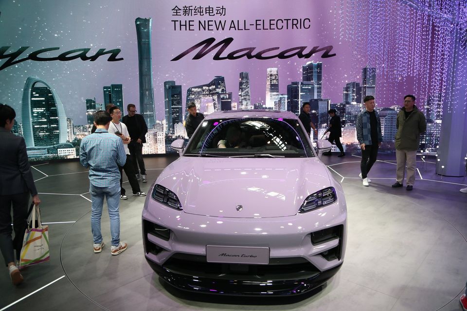 A Porsche Macan Turbo is displayed as people visit the 18th Beijing International Automotive Exhibition (Auto China) on April 25, 2024, Beijing, China. (Photo by Li Yueran/Anadolu via Getty Images)