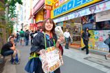 thumbnail: A girl tries to draw customers into an Owl Cafe in Akihabara, Tokyo