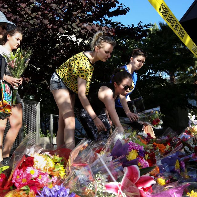 Visitors lay flowers on a makeshift memorial near the scene of a 4th-story apartment building balcony collapse in Berkeley, California