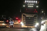 thumbnail: Rush Haulier N. Jones with one of his five trucks that were on the run. Photo Jack Corry