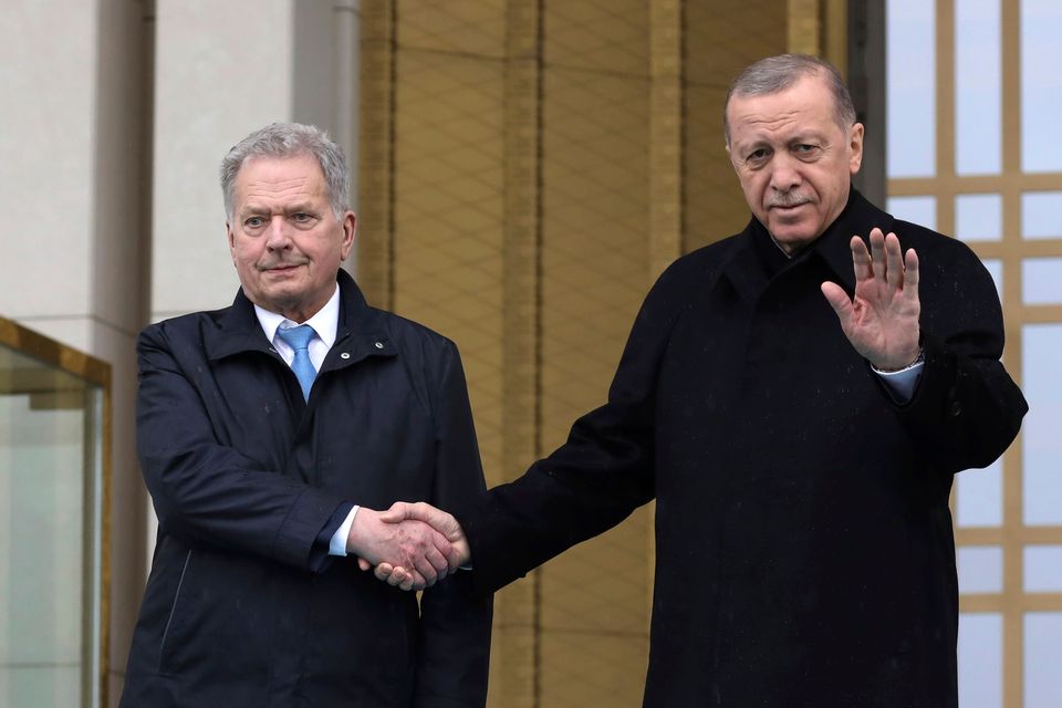 Turkish President Recep Tayyip Erdogan, right, and Finland’s President Sauli Niinisto shake hands during a welcome ceremony at the presidential palace in Ankara, Turkey (Burhan Ozbilici/AP/PA)