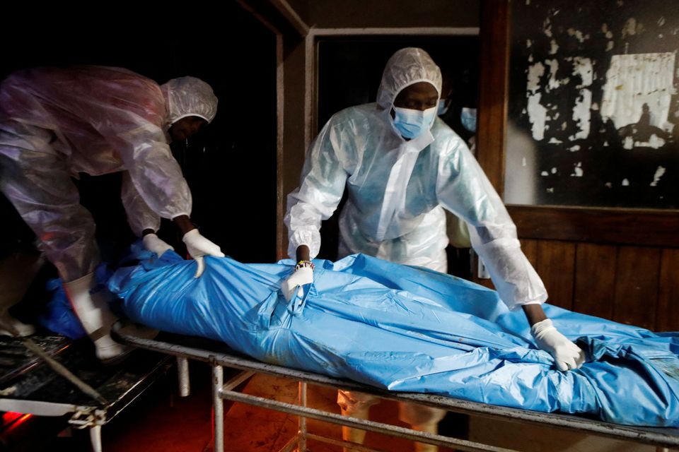 Workers with the exhumed bodies in Kenya