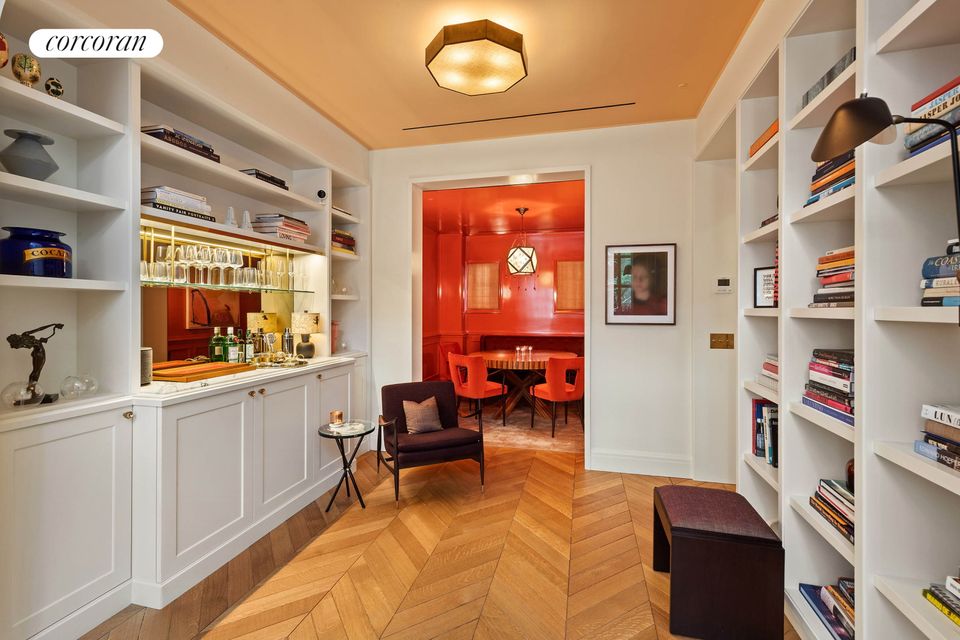 Inside the house with herringbone wooden floors and shelving