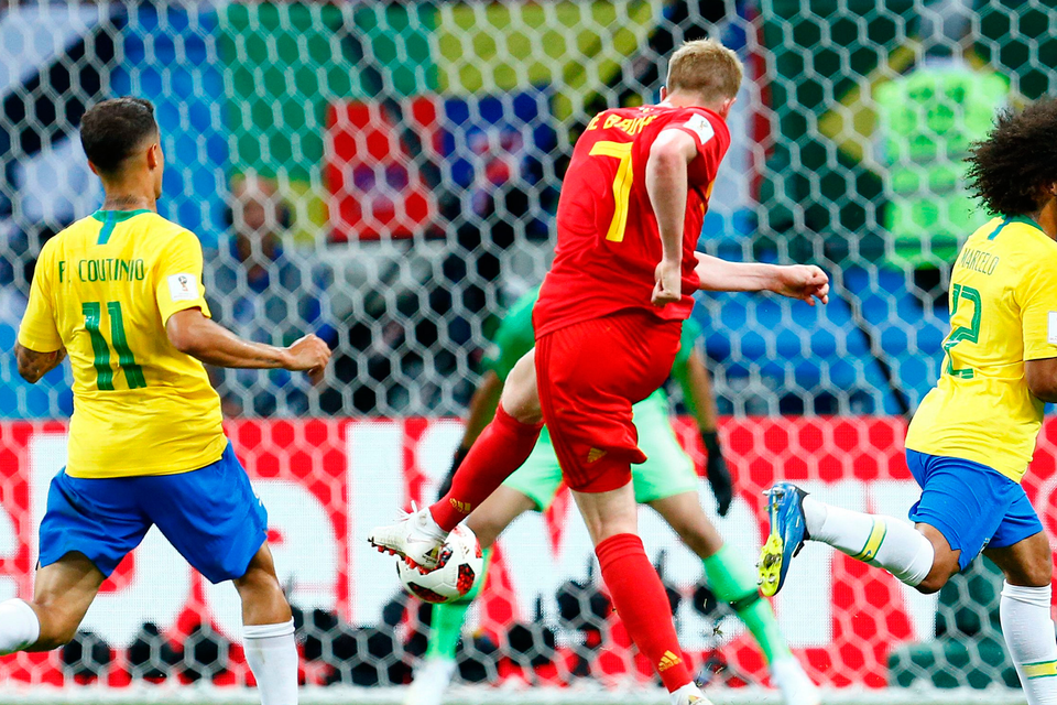 Kevin De Bruyne fires Belgium’s second goal despite the efforts of Brazilian defender Marcelo. Photo: Getty Images