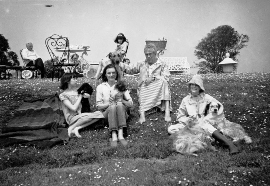 The Huston family with their dogs on the lawn of St Clerans in 1962