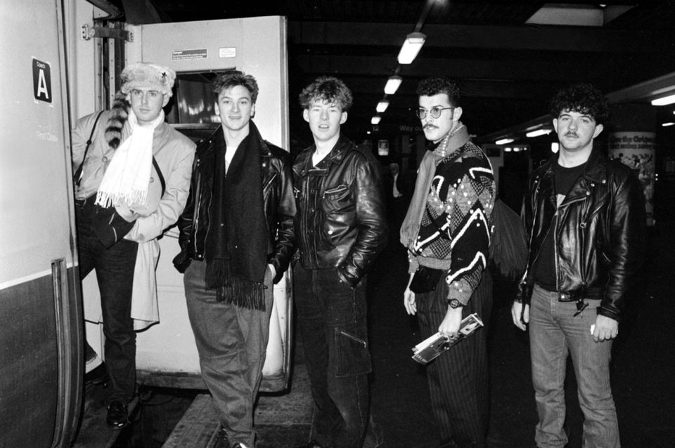 Lead singer of Frankie Goes to Hollywood, Holly Johnson (left) leads the group on to a train bound for Liverpool at London’s Euston Station (PA Archive)