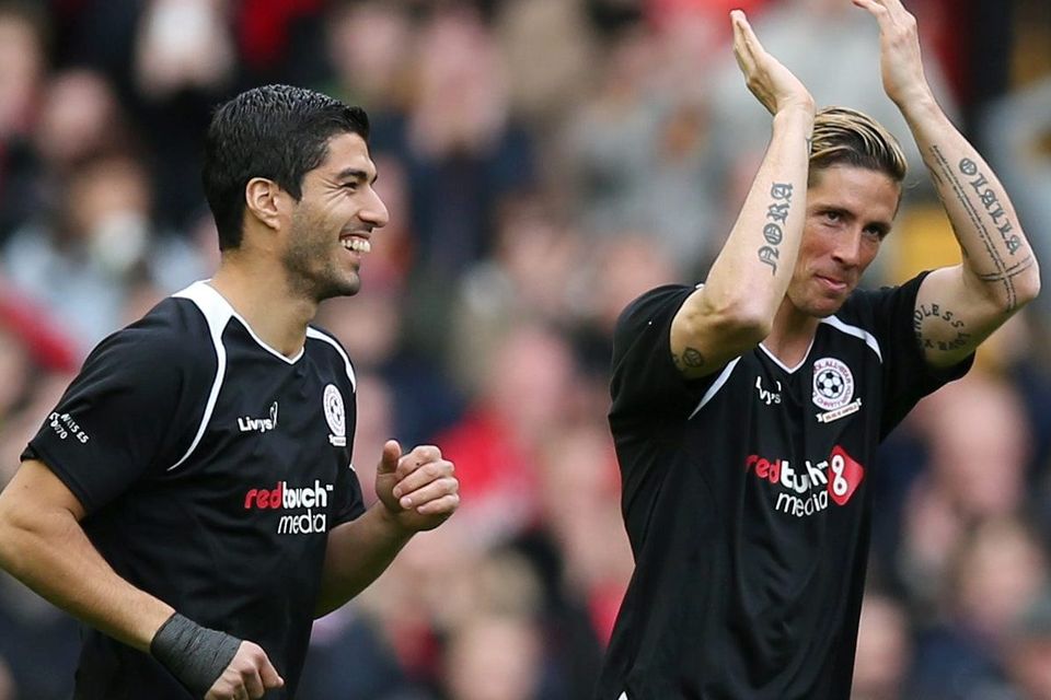 Luis Suarez and Fernando Torres making their way onto the pitch at Anfield yesterday