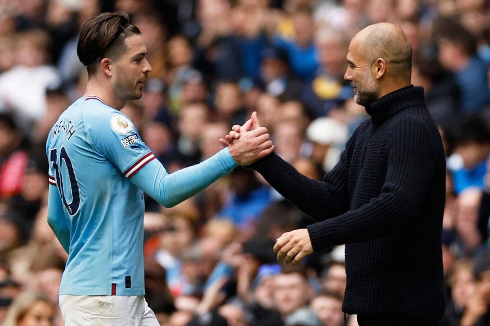Manchester City's Jack Grealish shakes hands with manager Pep Guardiola after being substituted late on in their victory over Liverpool at Etihad Stadium. Photo: Jason Cairnduff/Reuters