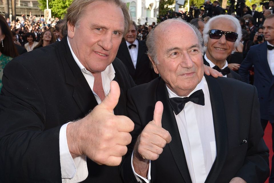 French actor Gerard Depardieu (L) and FIFA President Sepp Blatter give a thumbs-up as they arrive for the screening of the film "United Passions" at the 67th edition of the Cannes Film Festival in Cannes, southern France, in May 18