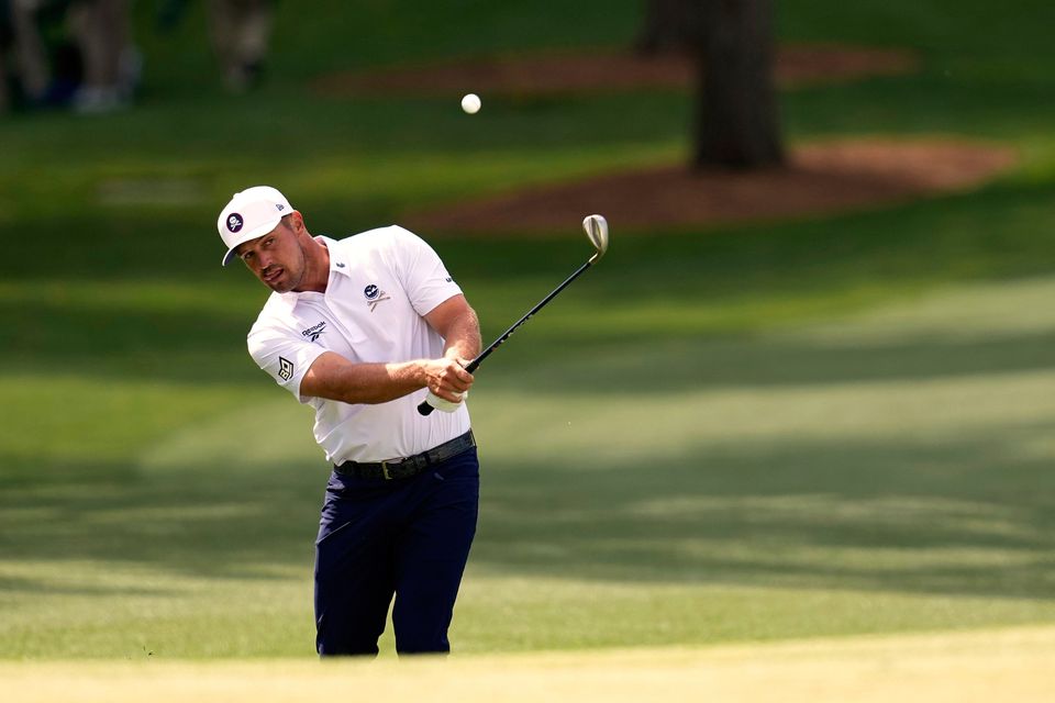 Bryson DeChambeau chips to the green on the seventh hole during the third round at the Masters. Photo: AP Photo