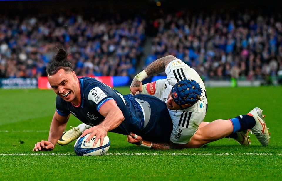 James Lowe dives over to score Leinster's fifth try despite the tackle of Jack Nowell of La Rochelle at the Aviva Stadium in Dublin. Photo by Ramsey Cardy/Sportsfile