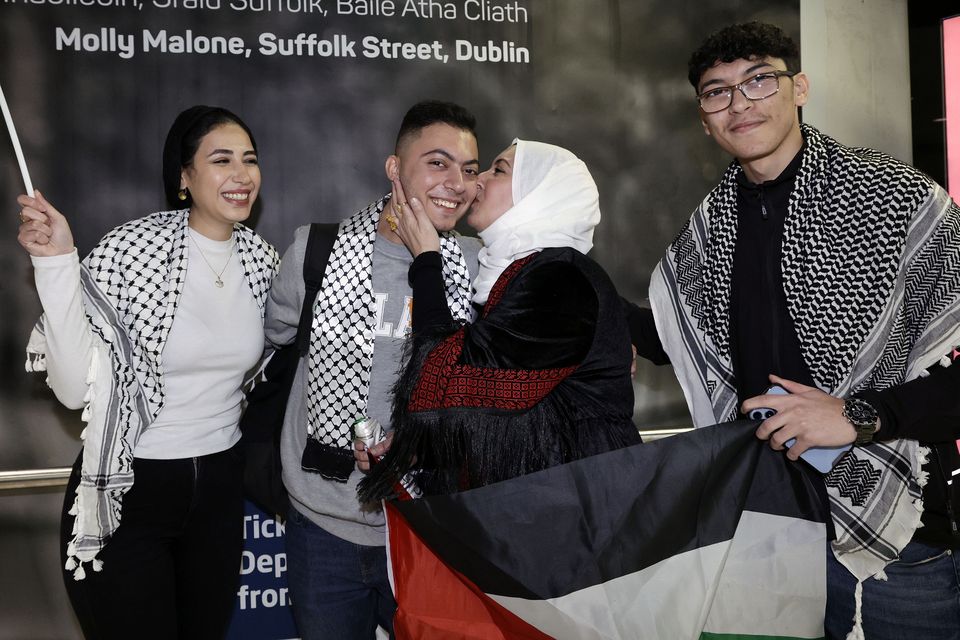 Saeed Sadeq (20) (second left)  returning from Gaza was greeted at Dublin Airport by (L-R) his cousin Asil, mother Jihan,  and brother Nidal. PIC: Conor Ó Mearáin / Collins Photo Agency