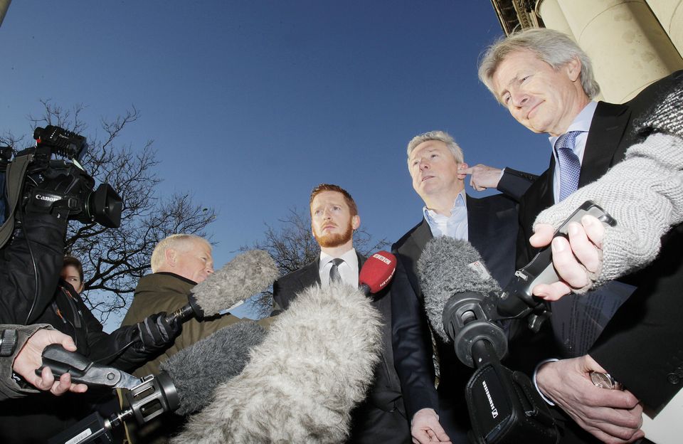 Louis Walsh (centre) speaks to the media with solicitors Paul Tweed (right) and Carl Rooney outside court after his defamation case. Photo: Julien Behal