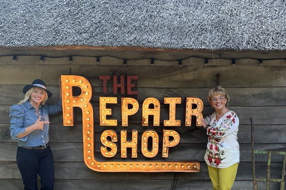 Dearbhla Lennon and Mona Roddy with the iconic Repair Shop sign outside 'the workshop of dreams'
