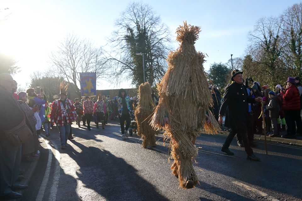 The Straw Bear is paraded through the streets accompanied by attendant keepers, musicians and dancers during the Whittlesea Straw Bear Festival (Joe Giddens/PA)