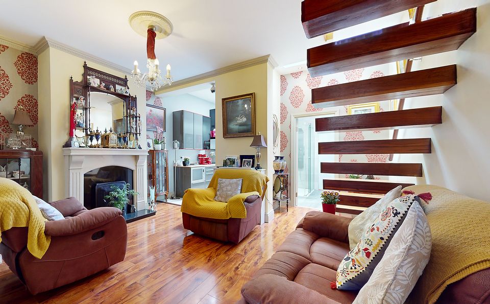 The more traditional living room with its super modern floating stairs