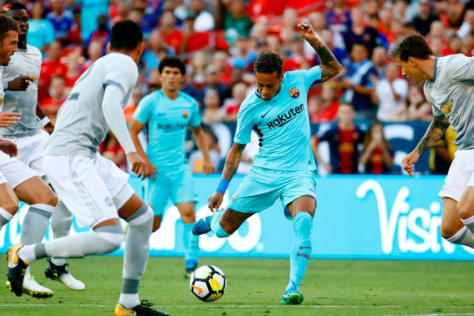 Barcelona's Neymar, center, shoots against Manchester United