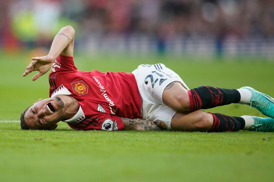 Manchester United's Antony lies on the pitch in pain during the English Premier League soccer match between Manchester United and Chelsea at the Old Trafford stadium in Manchester, England, Thursday, May 25, 2023. (AP Photo/Dave Thompson)