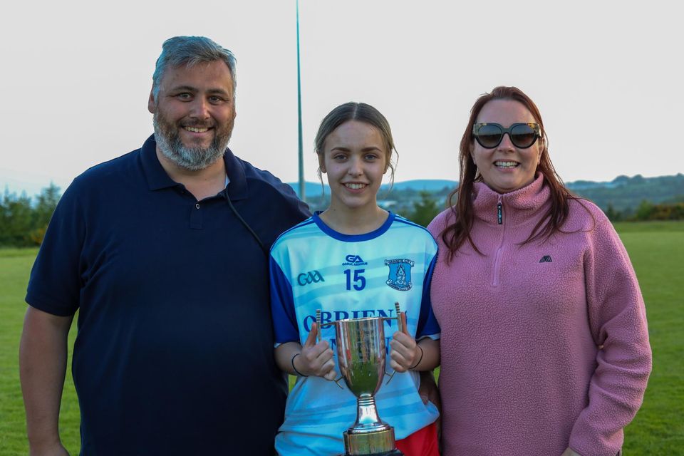 David, Chloe and Lisa Sheehy celebrate with the Intermediate league cup.