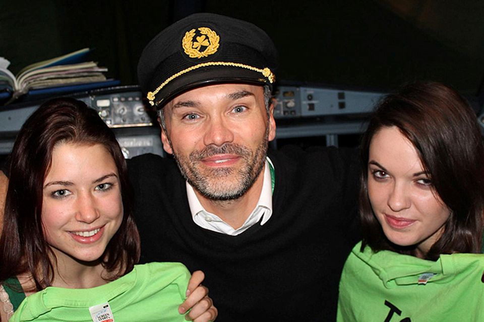 TCD students Rosie Goulding and Nicole O'Sullivan (right) with a pilot during thier TCD Jailbreak adventure