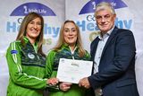 thumbnail: Newtown GAA Club's Margaret Synnott and Nicola Fitzsimons being presented with their gold award by Leinster Council Health and Wellbeing Chairperson Dave Murray. 