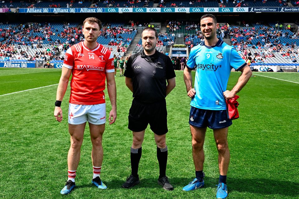 Captains Sam Mulroy of Louth and James McCarthy of Dublin with referee Noel Mooney. Photo: Harry Murphy/Sportsfile