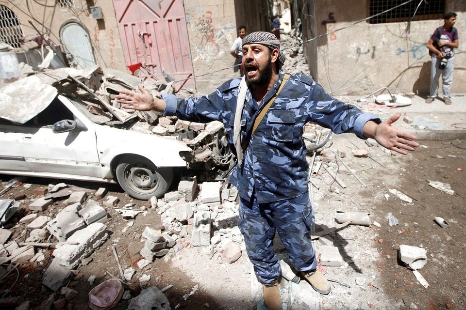 A Houthi security officer reacts at the site of an air strike launched by the Saudi-led coalition in Sanaa, Yemen. Photo: Mohamed al-Sayaghi/Reuters