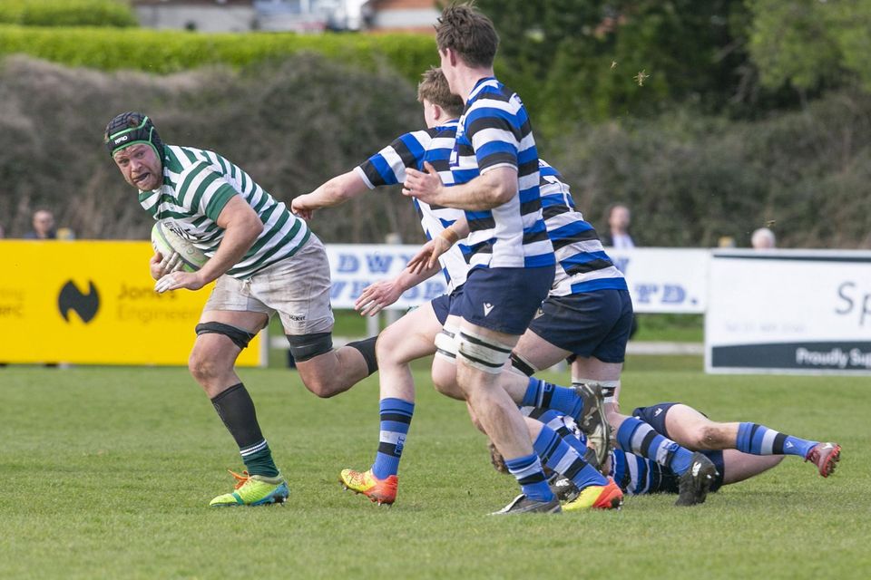 Greystones player/coach Danny Kenny gets away from the chasing Corinthians pack.