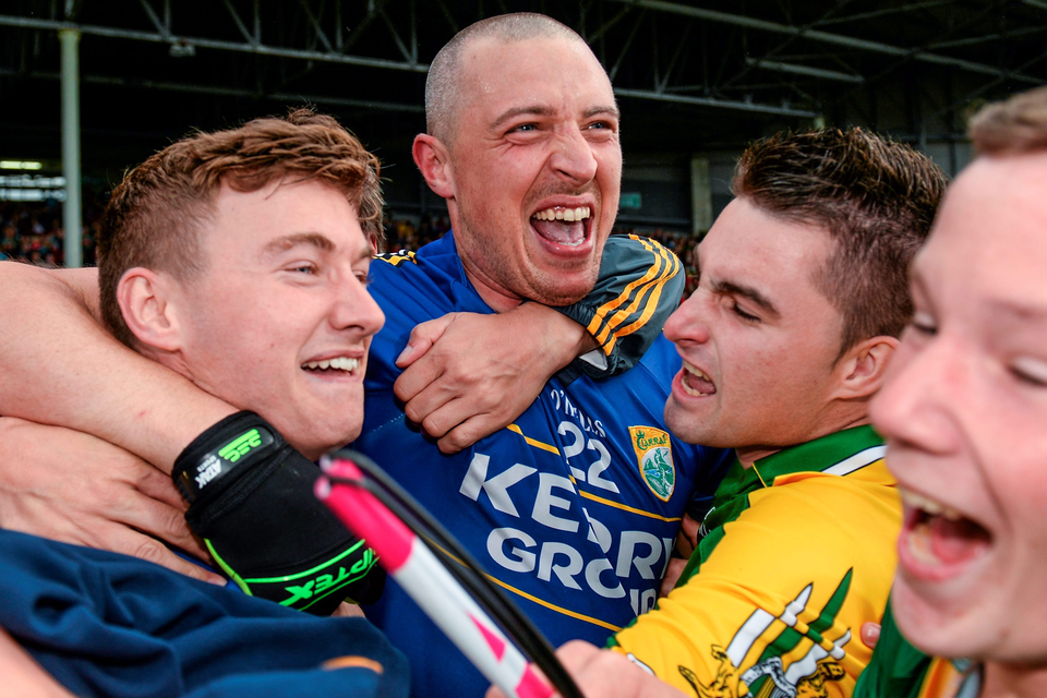 Kerry's Kieran Donaghy, centre, and James O'Donoghue celebrate with fans after the final whistle.