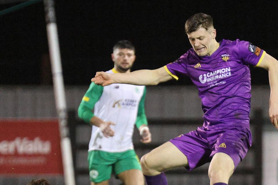 Goalscorer Mark Hanratty evades Samuel Alsdesanusi of Kerry FC.