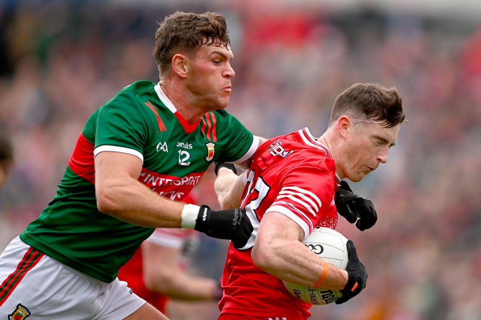 Gareth McKinless of Derry in action against Jordan Flynn of Mayo