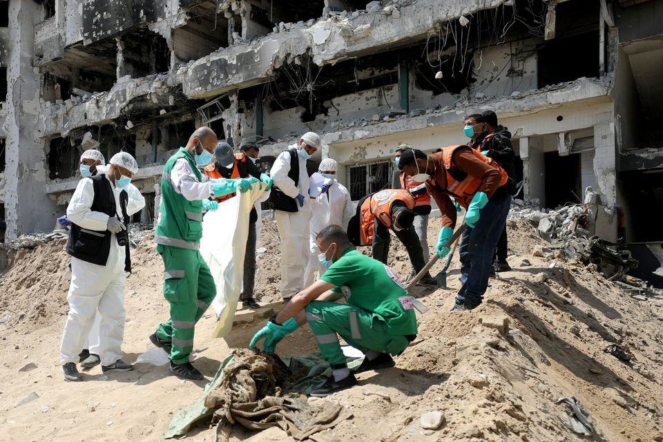 Rescuers and medics search for bodies inside the damaged Al-Shifa Hospital in Gaza after Israeli forces withdrew from the area following a two-week operation. Photo: Reuters