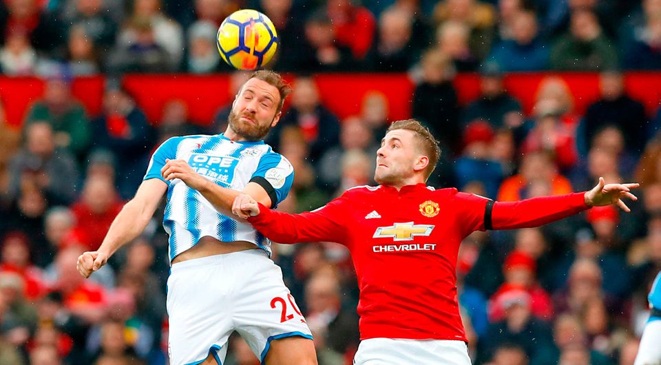 Huddersfield Town's Laurent Depoitre (left) and Manchester United's Luke Shaw battle for the ball at Old Trafford. Photo: Martin Rickett/PA