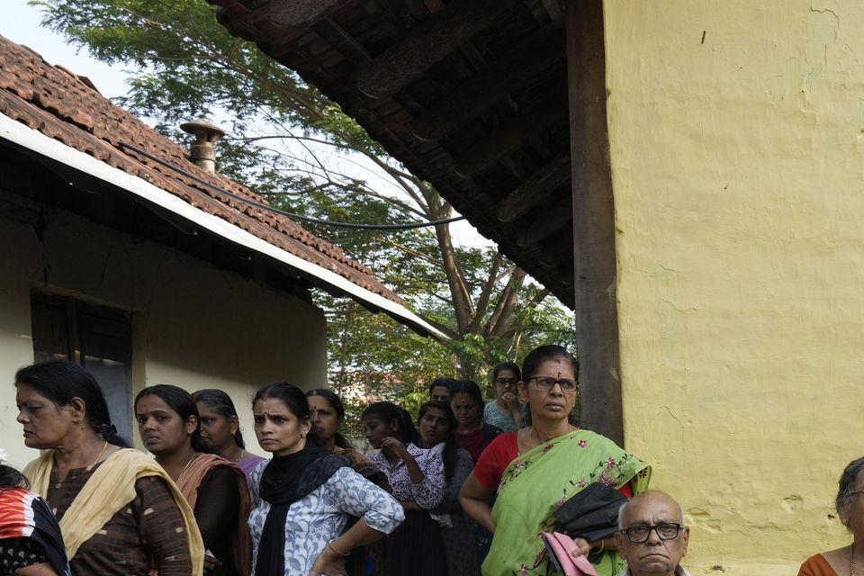 Elderly voters sit as others stand in a queue to vote during the second round of voting in the six-week-long national election near Palakkad, India (Manish Swarup/AP)