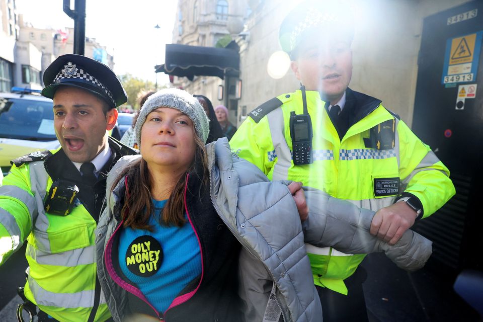 Police officers detain Swedish climate campaigner Greta Thunberg during an Oily Money Out and Fossil Free London protest in London. Photo: Toby Melville