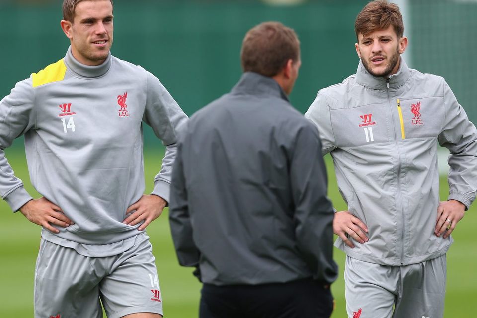 Liverpool manager Brendan Rodgers has a word with L-R Jordan Henderson and Adam Lallana during a training session ahead of their UEFA Champions League group B match against PFC Ludogorets