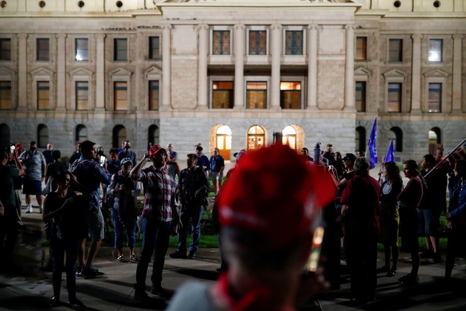 Supporters of U.S. President Donald Trump gather in front of the Arizona State Capitol Building to protest about the early results of the 2020 presidential election, in Phoenix, Arizona November 4, 2020. REUTERS/Edgard Garrido