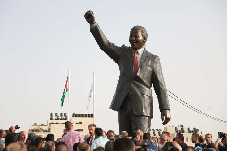 A sculpture of Nelson Mandela is erected in Ramallah, West Bank, in 2016. Photo: Getty