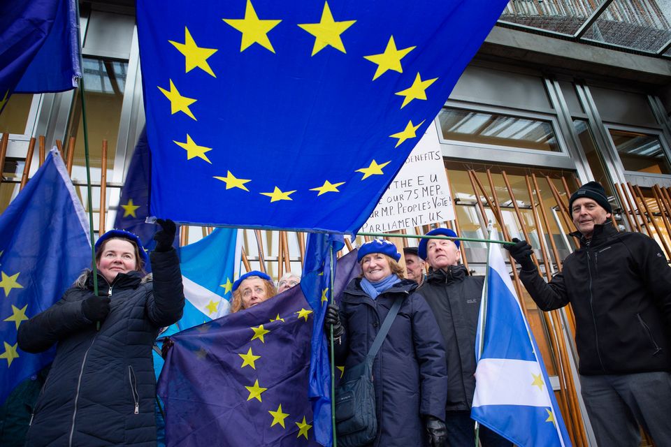 Pro-European protestors outside the Scottish Parliament, Edinburgh, as a vote is held against Theresa May's proposed Brexit deal with MSPs calling instead for a 'better alternative' to the PM's plans to be taken forward. Photo: Jane Barlow/PA Wire